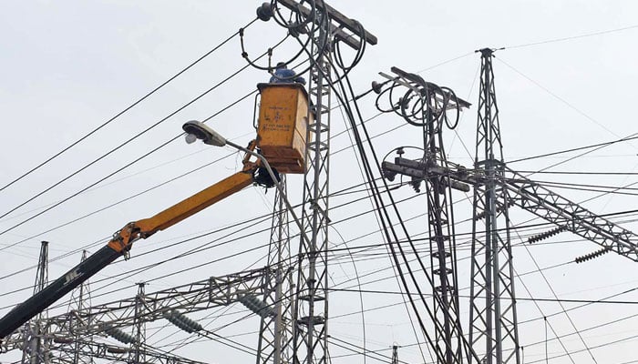 A WAPDA worker is busy repairing high power lines at the Shadman power station in Lahore on February 19, 2023. — Internet